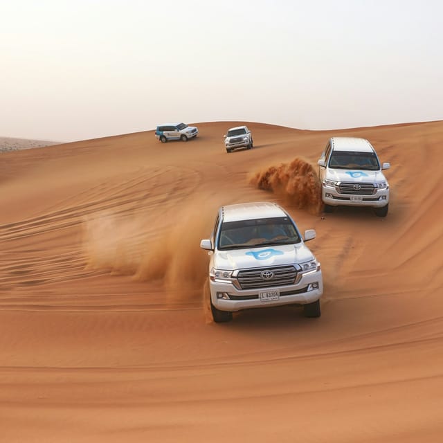 Desert Safari with Camel Ride, Sandboarding, BBQ Dinner & Optional Quad Ride - Photo 1 of 10